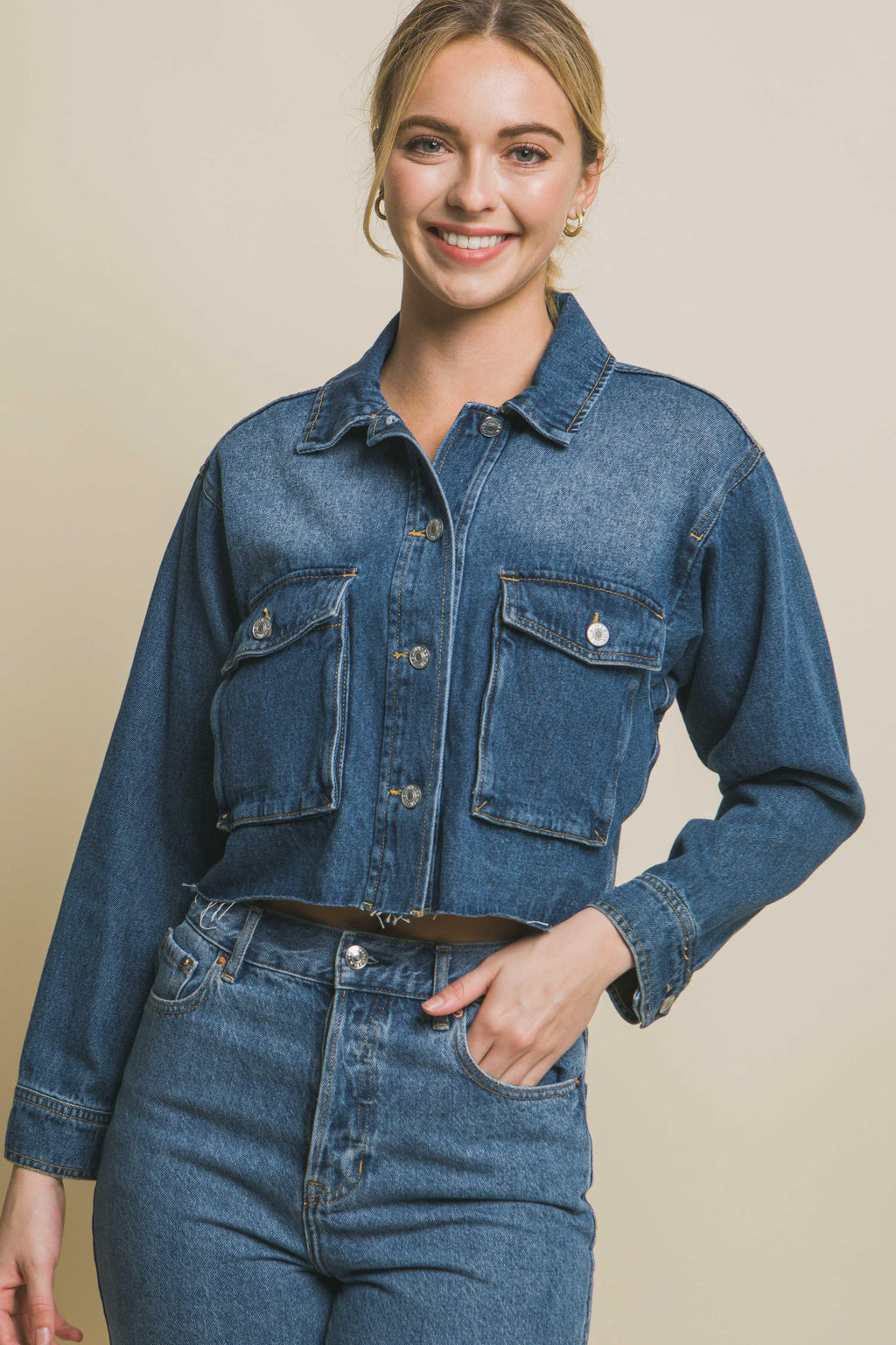 cropped denim jacket with button front closure and raw hem line