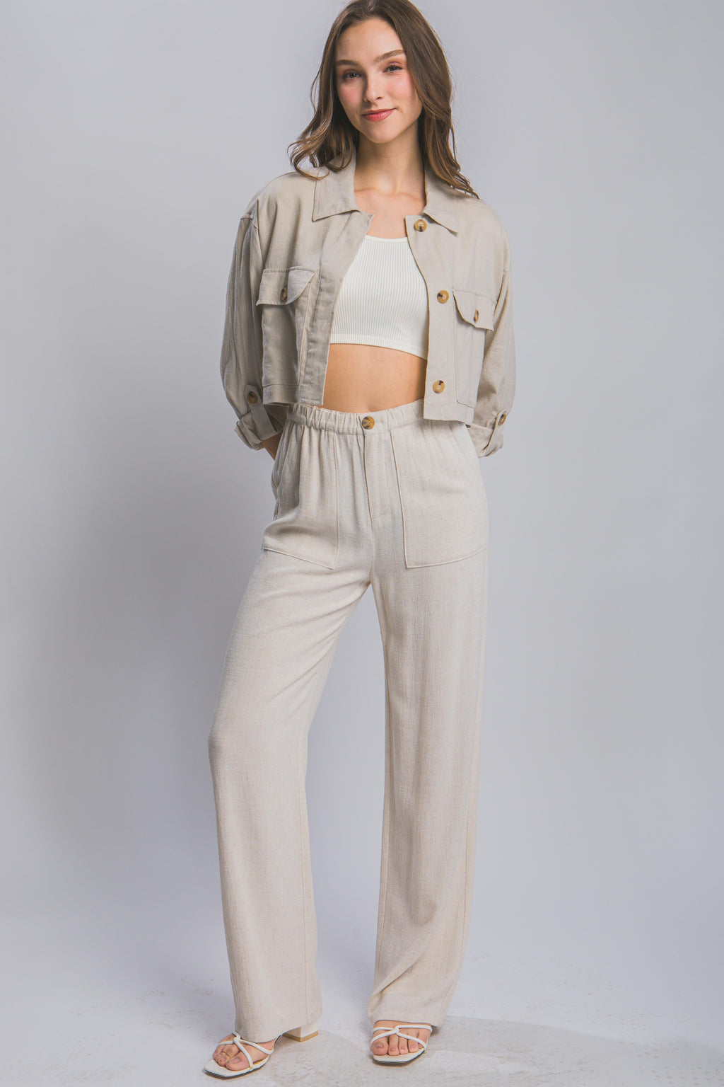 Long Ivory linen pants with dual side pockets and button front closure
