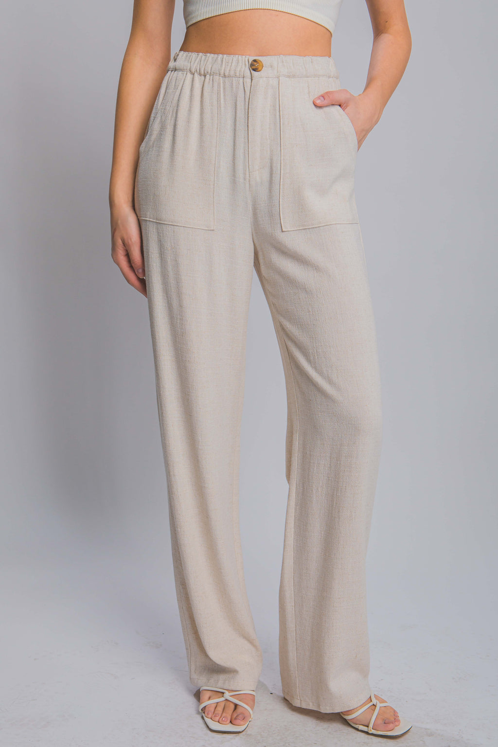 Long Ivory linen pants with dual side pockets and button front closure